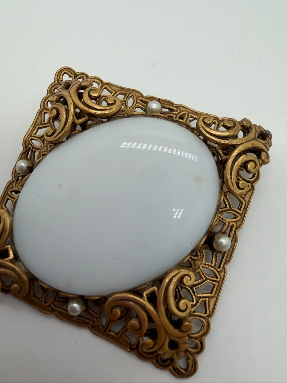 Victorian style filigree gold tone milk glass brooch